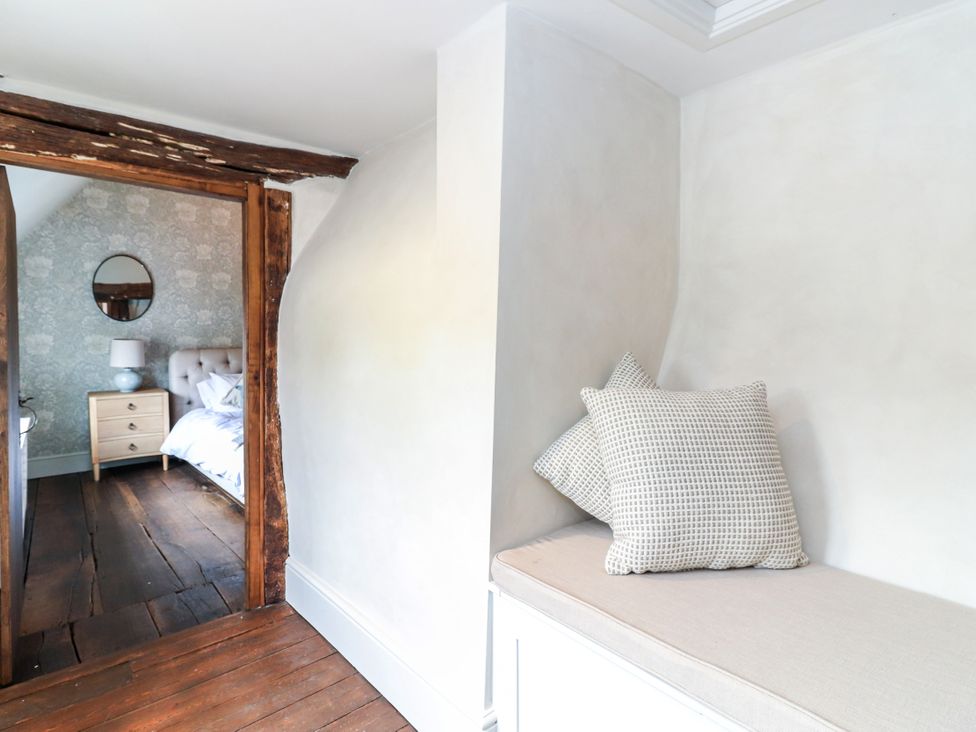 A bedroom with a mirror and bed visible at Tuffs Farm Cottage 1 Kings Langley