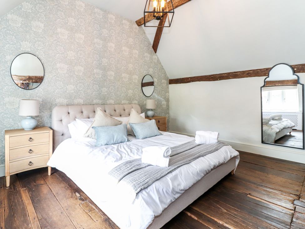 A bedroom with bed and bedside tables at Tuffs Farm Cottage 1 Kings Langley