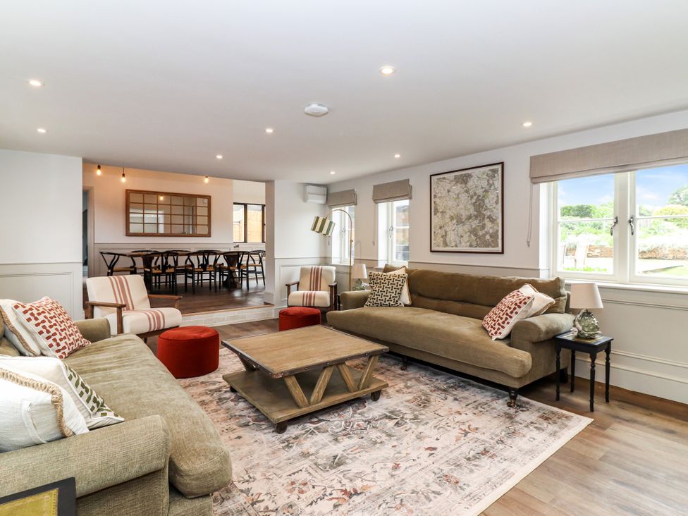 A living room with a sofa and coffee table at Tuffs Farm Cottage 2 in Kings Langley
