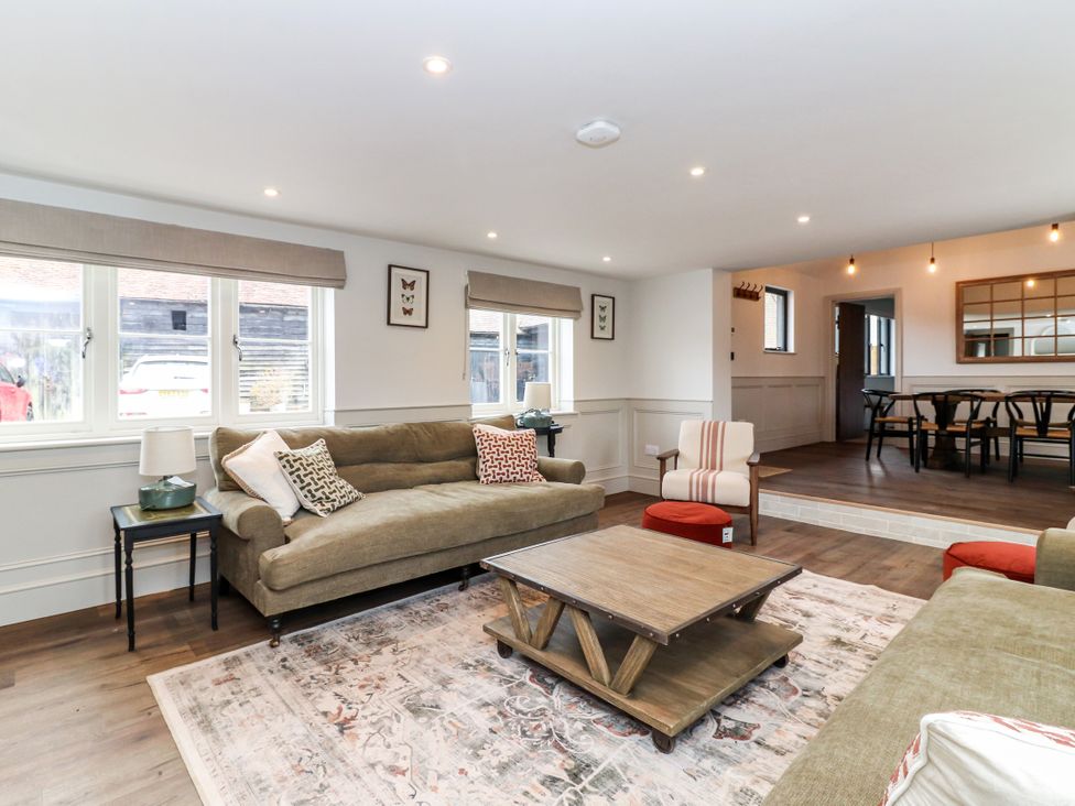 A living room with sofas and a coffee table at Tuffs Farm Cottage 2 in Kings Langley