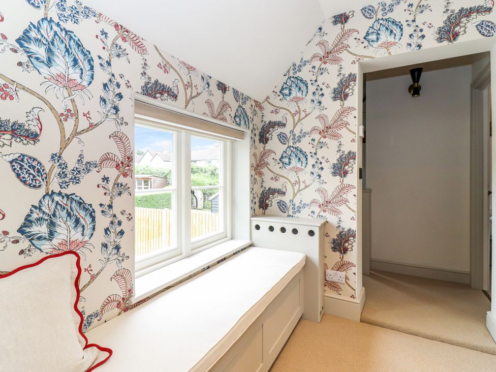 A hallway with a window and a bench at Tuffs Farm Cottage 2 Kings Langley