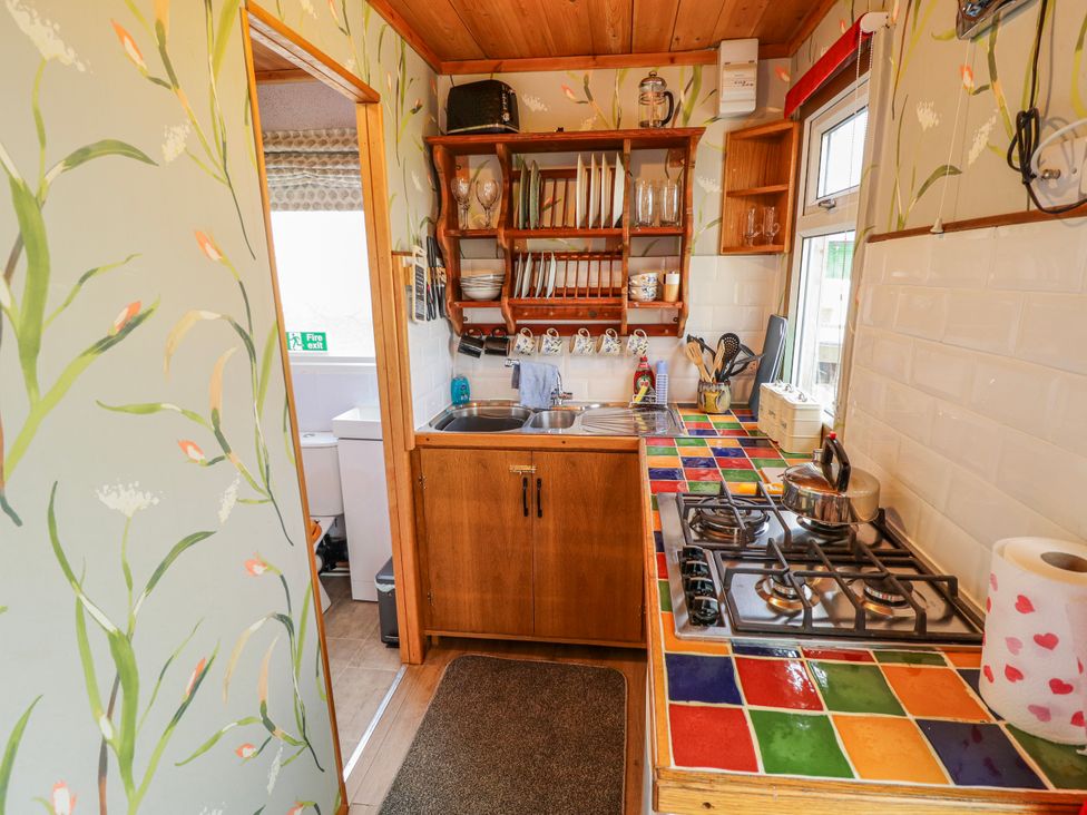 A kitchen with a sink and stove at Riverside Cabin in Peterborough