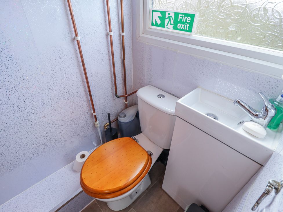 A bathroom featuring a toilet and sink at Riverside Cabin in Peterborough