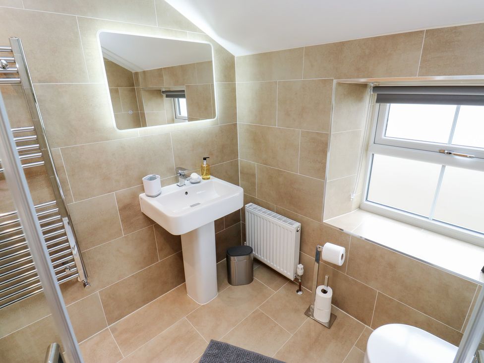 A bathroom with a sink and toilet at Moss Cottage in Cragg Vale