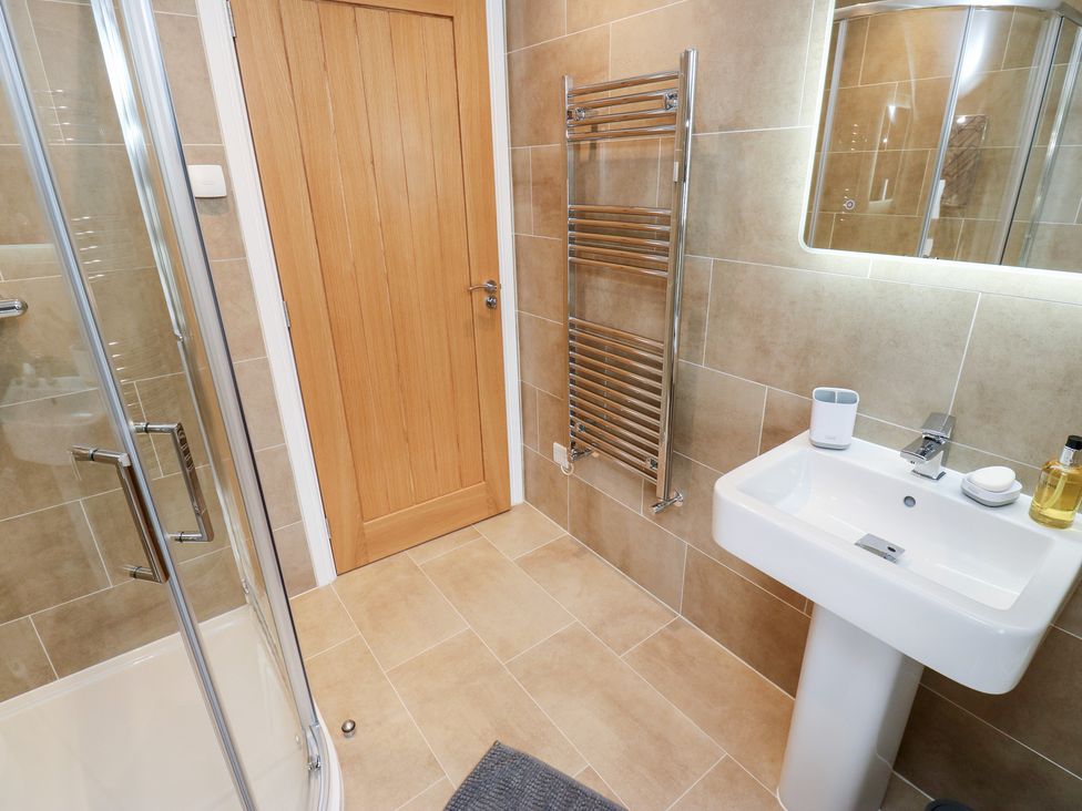 A bathroom with a shower and sink at Moss Cottage Cragg Vale