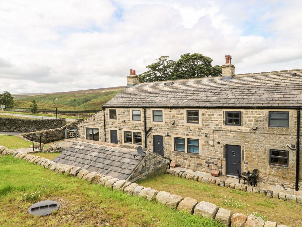 A house with stone exterior and garden at Moss Cottage in Cragg Vale