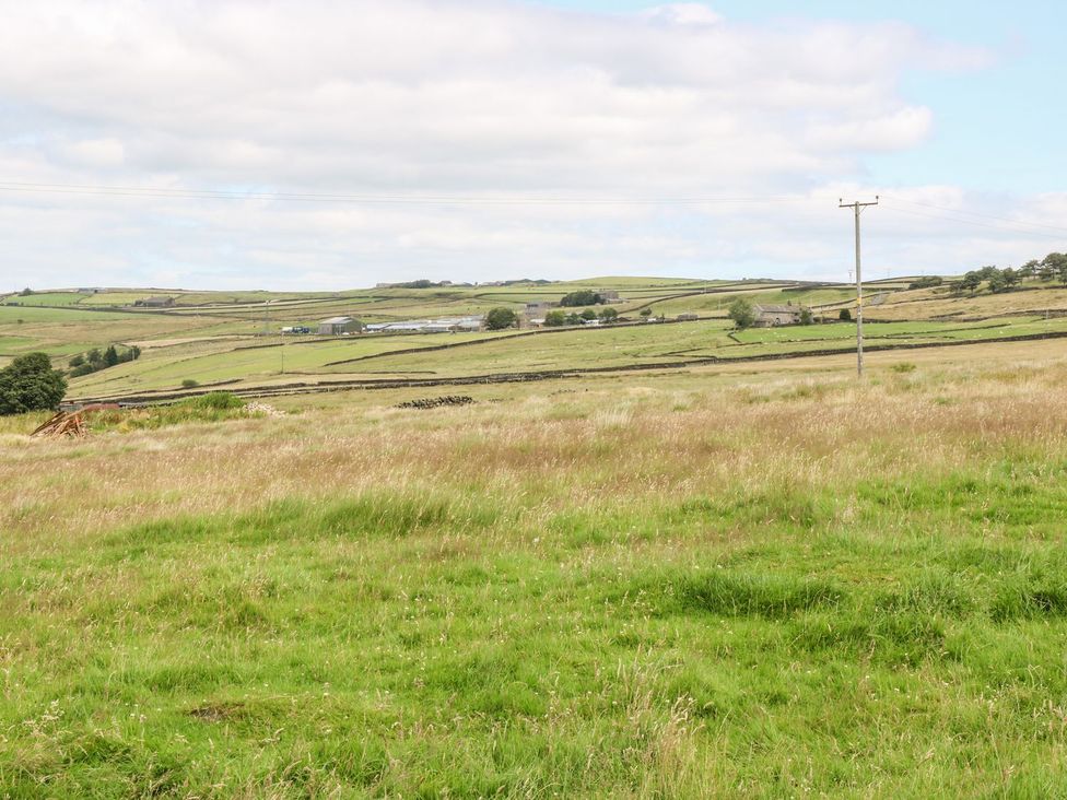 A landscape with fields and hills at Moss Cottage in Cragg Vale
