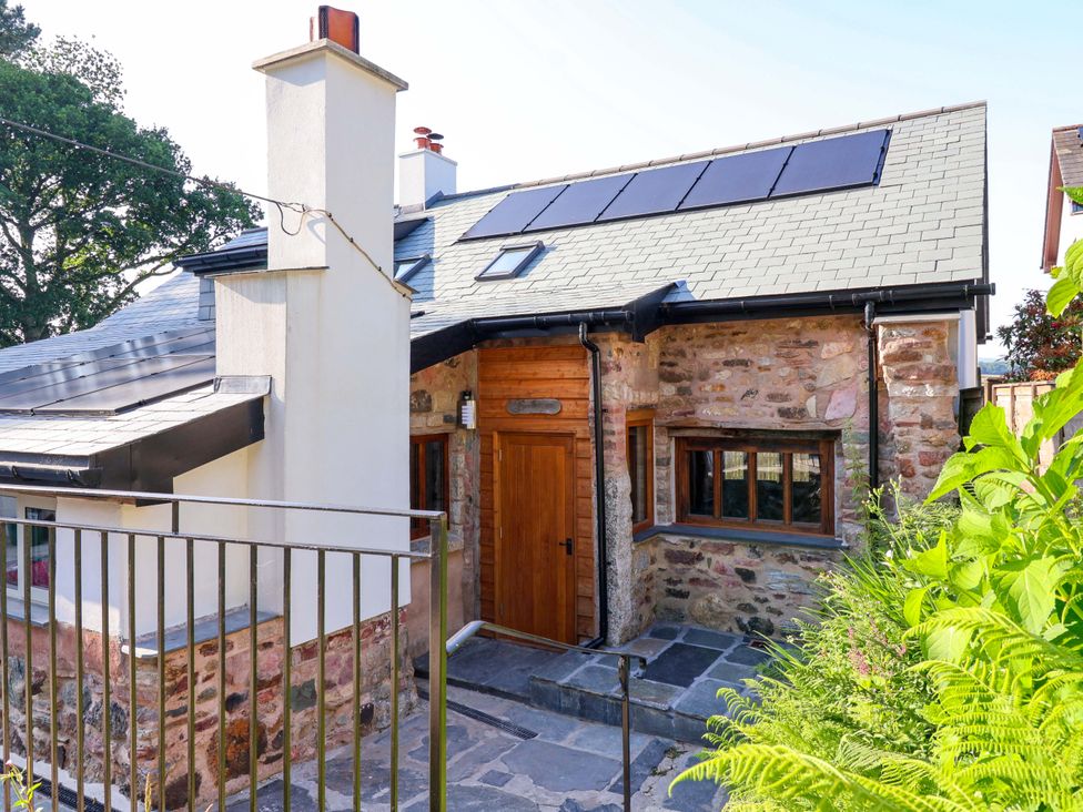 A house with a wooden door and solar panels at Heathmoor in Horrabridge