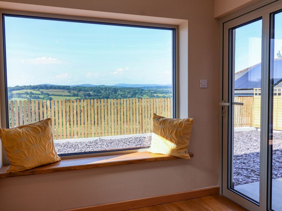 A sitting room with a view of fields and hills at Heathmoor in Horrabridge