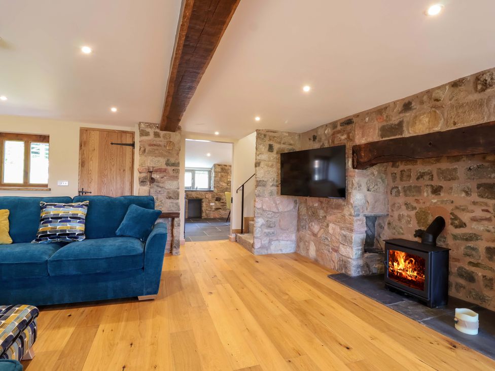 A living room with a fireplace and television at Heathmoor in Horrabridge