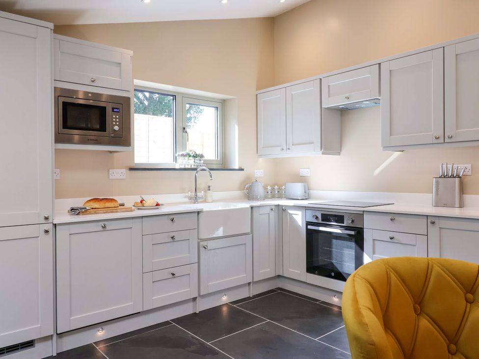 A kitchen with cabinets and countertop at Heathmoor in Horrabridge