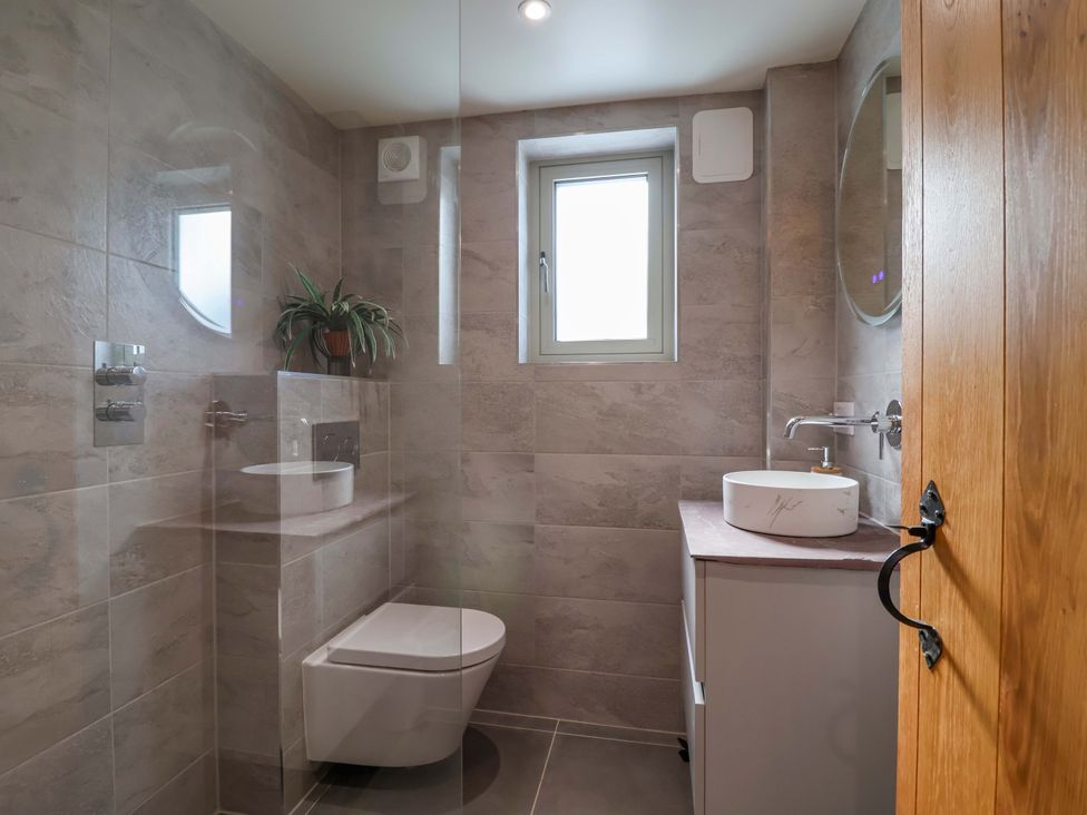 A bathroom with a toilet sink and shower at Heathmoor in Horrabridge