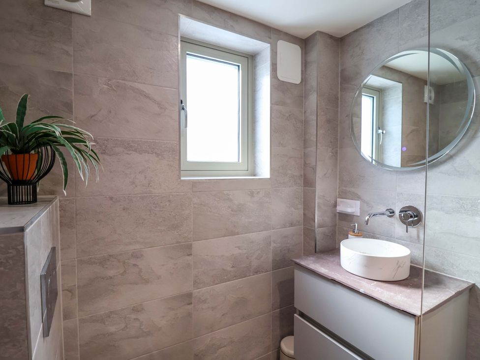 A bathroom with a sink and mirror at Heathmoor in Horrabridge