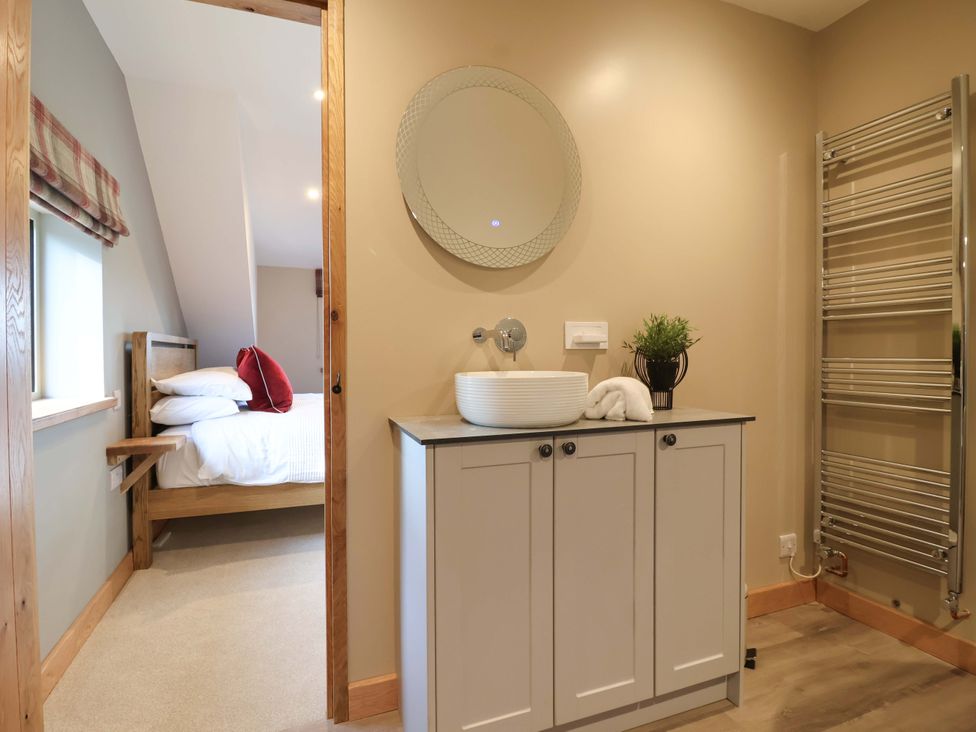 A bathroom with a sink and towel warmer at Heathmoor in Horrabridge