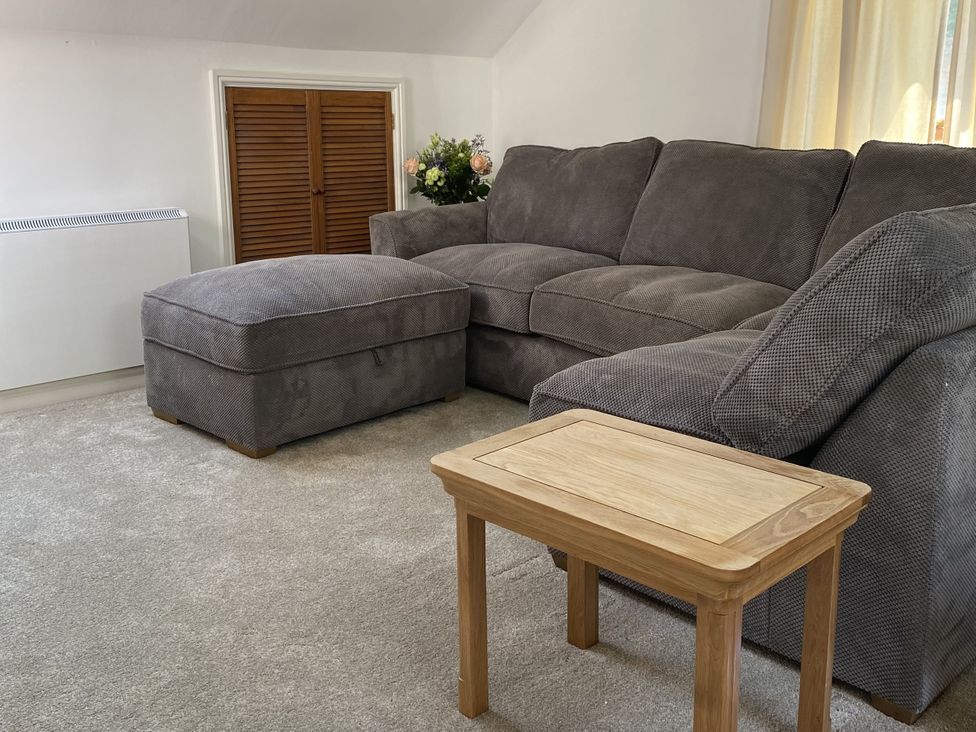 A living room with a sofa and ottoman at Old Forge Apartment in Wolverly