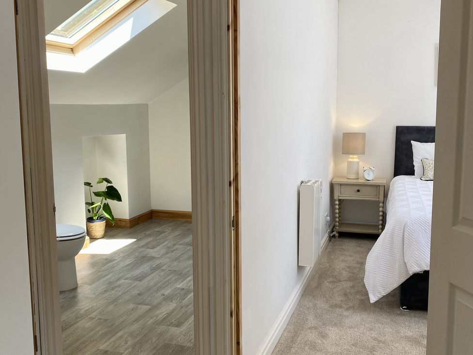 A bedroom with a bed and a toilet in view at Old Forge Apartment in Wolverly