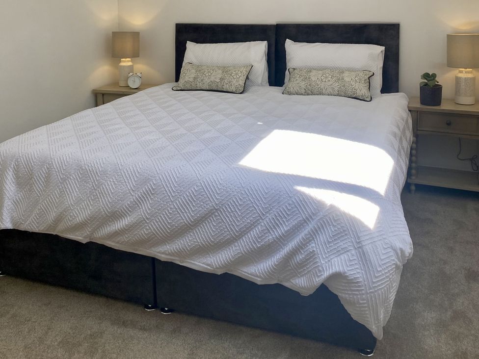 A bedroom with a bed and two nightstands at Old Forge Apartment in Wolverly