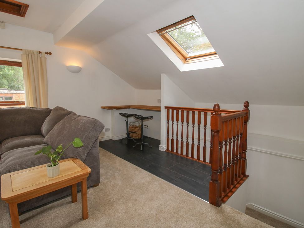 A living room with a sofa and table at Old Forge Apartment Cookley
