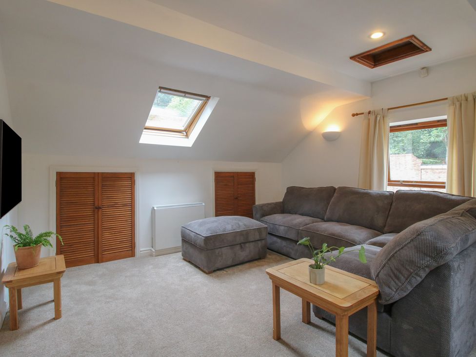 A living room with a sofa and coffee table at Old Forge Apartment in Cookley