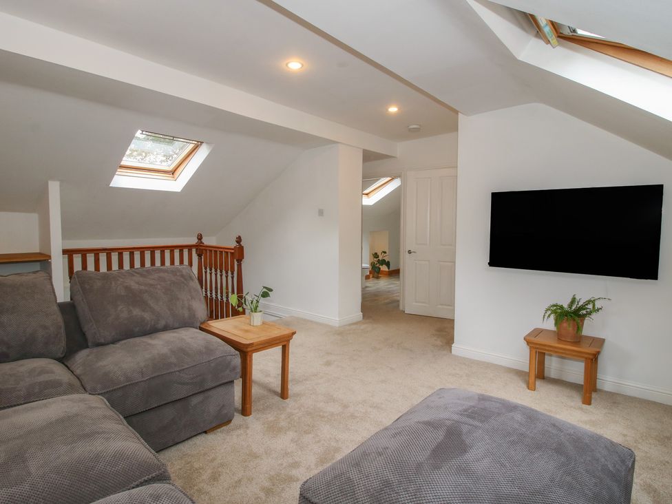 A snug with a sofa and television at Old Forge Apartment Cookley
