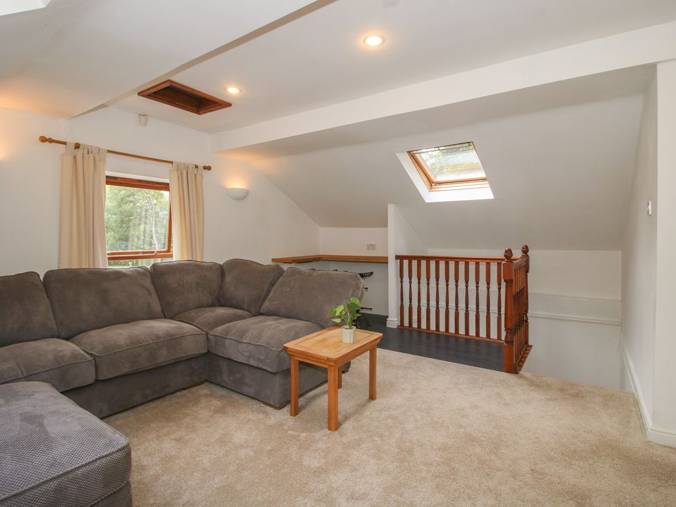 A living room with a sofa and coffee table at Old Forge Apartment in Cookley