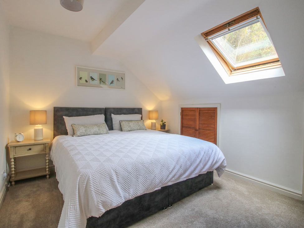 A bedroom with a bed and skylight at Old Forge Apartment in Cookley