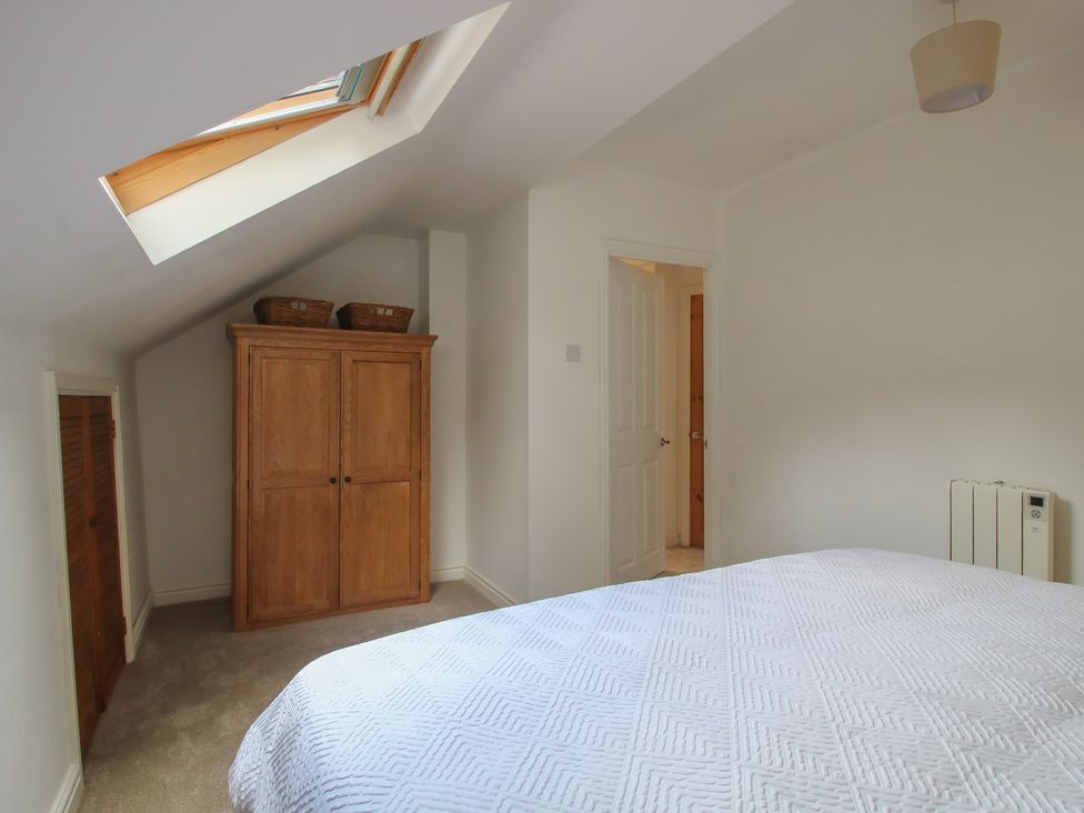 A bedroom with a bed and wardrobe at Old Forge Apartment in Cookley