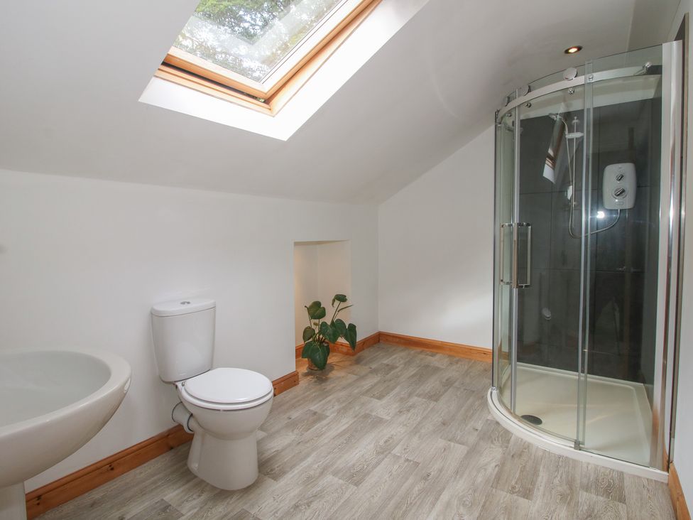 A bathroom with a sink, toilet, and shower at Old Forge Apartment in Cookley
