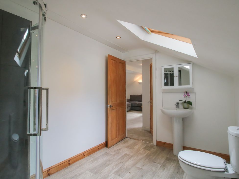 A bathroom with a shower and sink at Old Forge Apartment in Cookley
