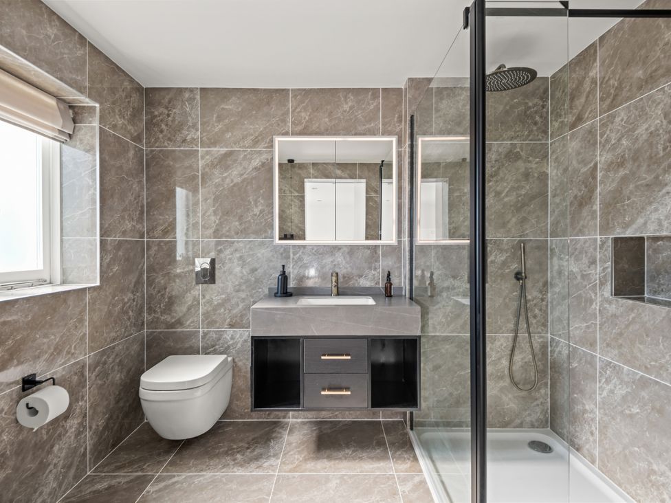 A bathroom with a shower, sink, and toilet at Capton Snug in Capton near Dartmouth