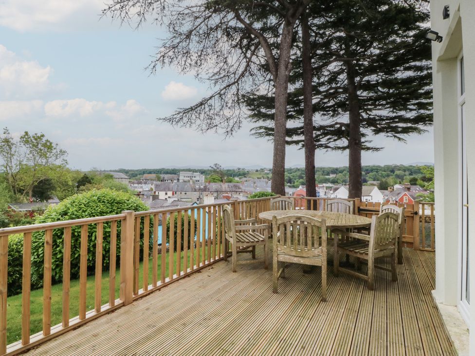 An outdoor seating area with a table and chairs at Fir Grove in Menai Bridge
