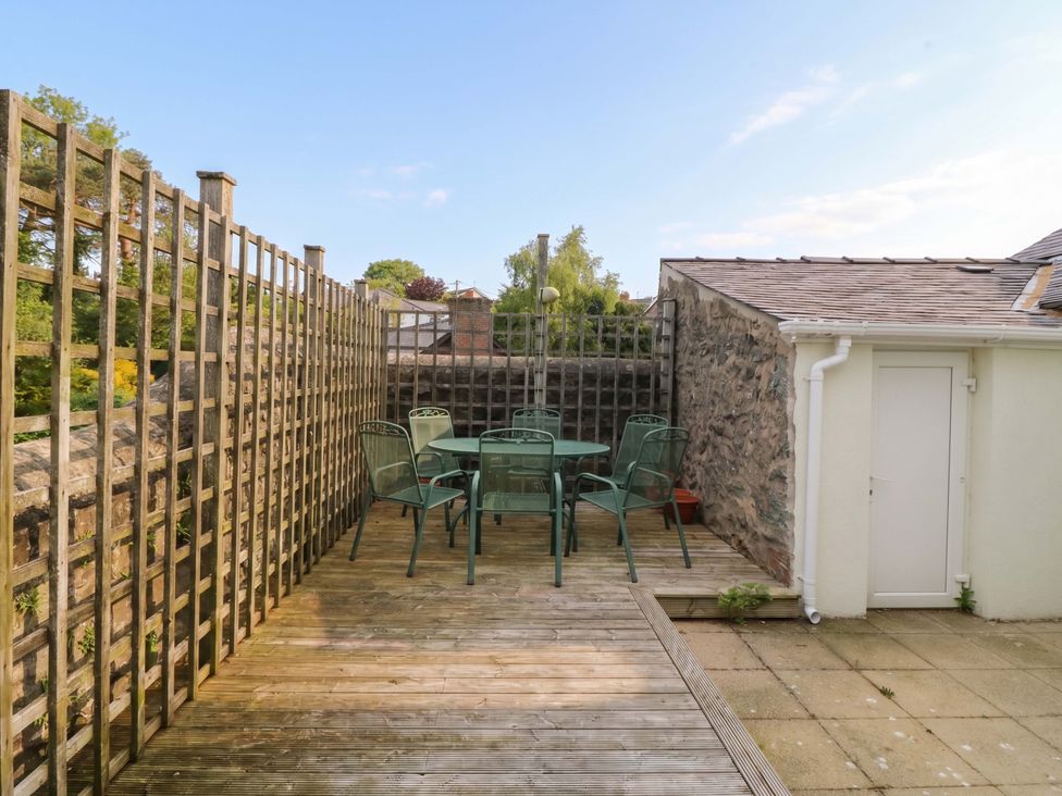 An outdoor seating area with a table and chairs at The Fir Grove Annex in Menai Bridge
