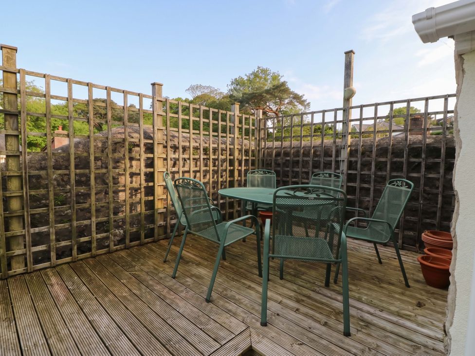 An outdoor space with a table and chairs at The Fir Grove Annex in Menai Bridge