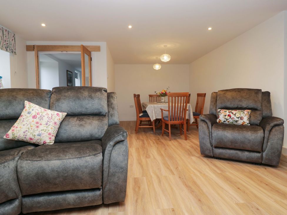 A living room with seating and dining area at New Barn Conversion in Sedbergh