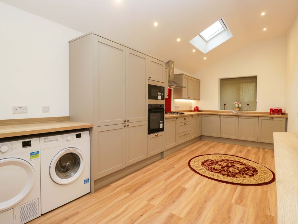 A kitchen with appliances and cabinets at New Barn Conversion Sedbergh