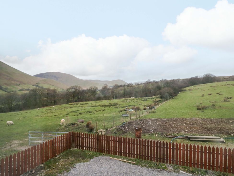 A view of a field with sheep and mountains at New Barn Conversion in Sedbergh