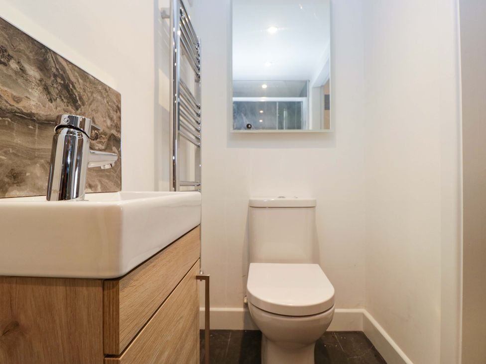 A bathroom with a sink and toilet at New Barn Conversion Sedbergh