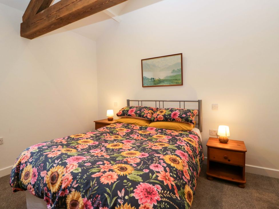A bedroom with a bed and nightstands at New Barn Conversion in Sedbergh