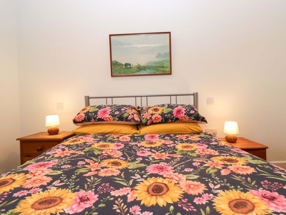 A bedroom with a bed and bedside tables at New Barn Conversion Sedbergh