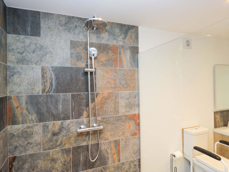 A bathroom with a shower and toilet at New Barn Conversion Sedbergh