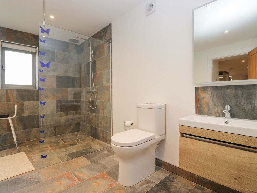 A bathroom with a shower, toilet and sink at High Birks Barn Cautley near Sedbergh