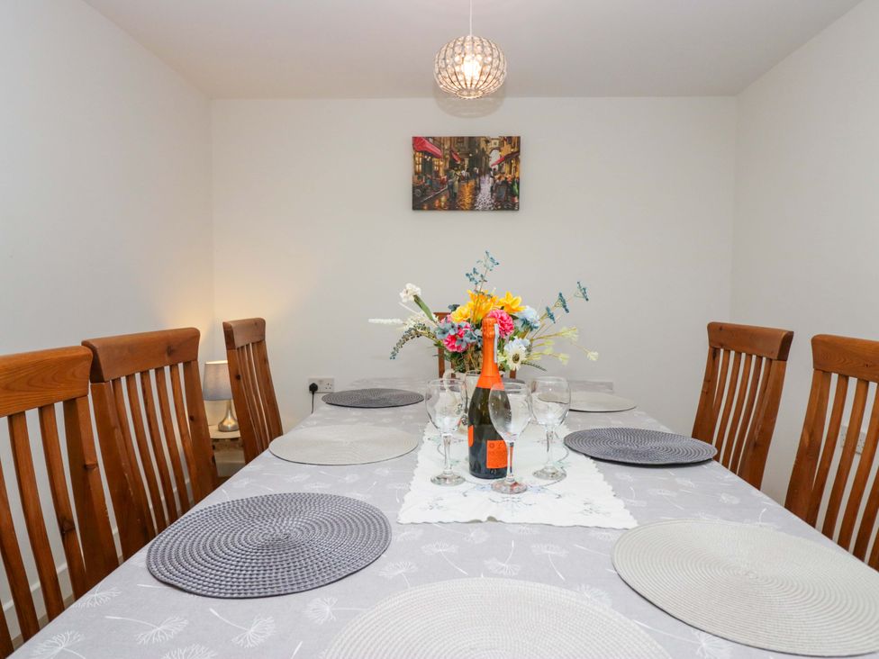 A dining room with a table set for a meal at High Birks Barn Cautley near Sedbergh