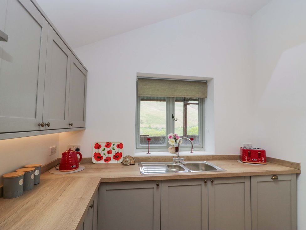 A kitchen with sink and window at High Birks Barn in Cautley near Sedbergh