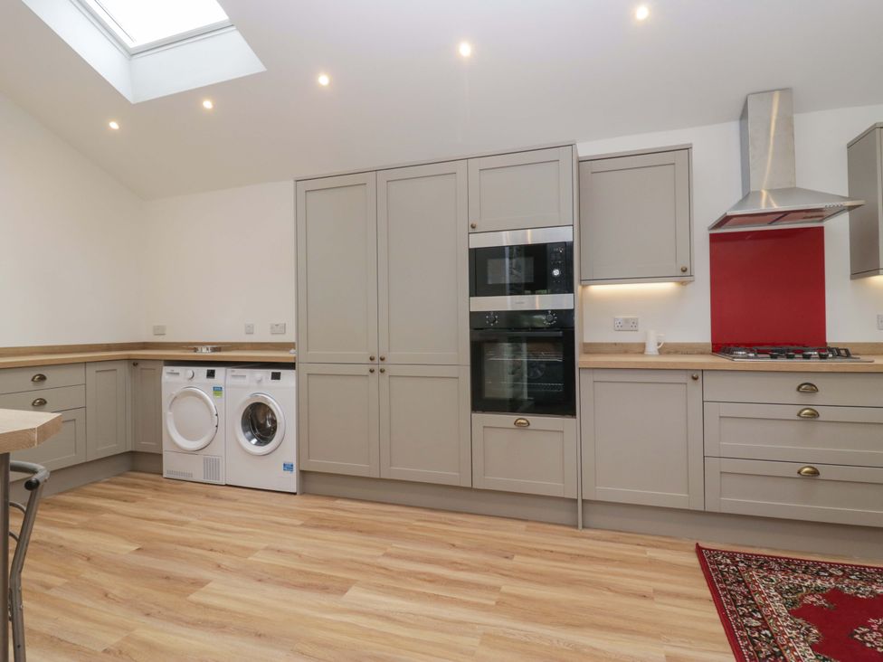 A kitchen with a washing machine and dryer at High Birks Barn Cautley near Sedbergh