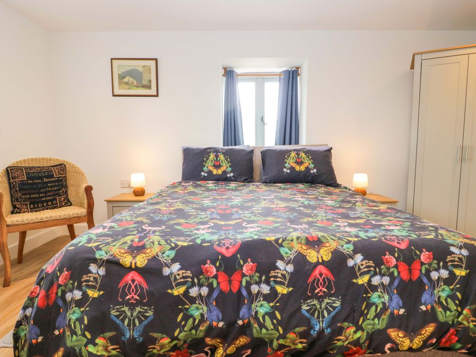 A bedroom with a bed and nightstand at High Birks Barn in Cautley near Sedbergh