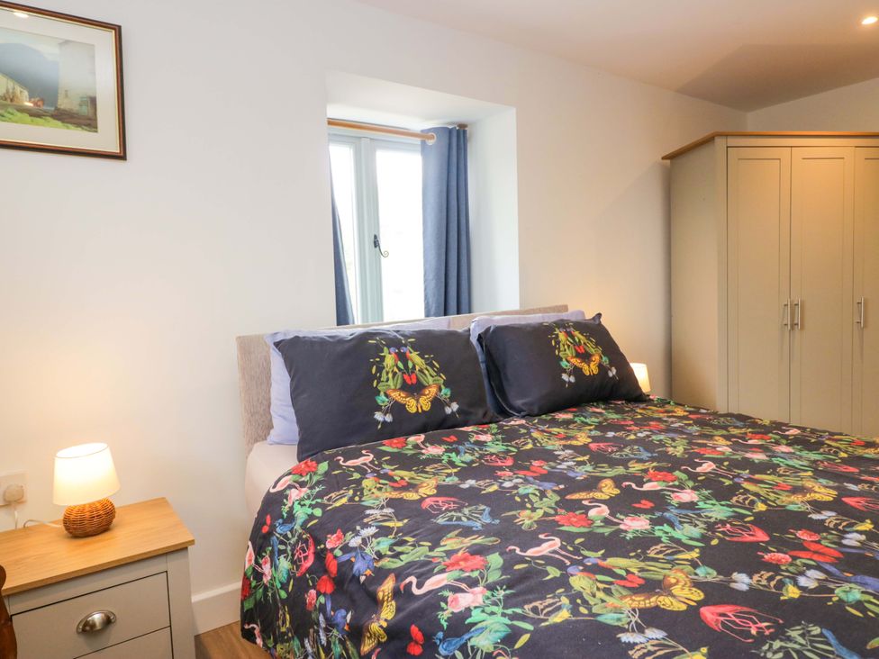A bedroom with a bed and a wardrobe at High Birks Barn Cautley near Sedbergh