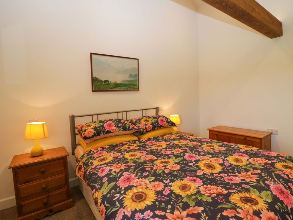 A bedroom with a bed and bedside tables at High Birks Barn Cautley near Sedbergh