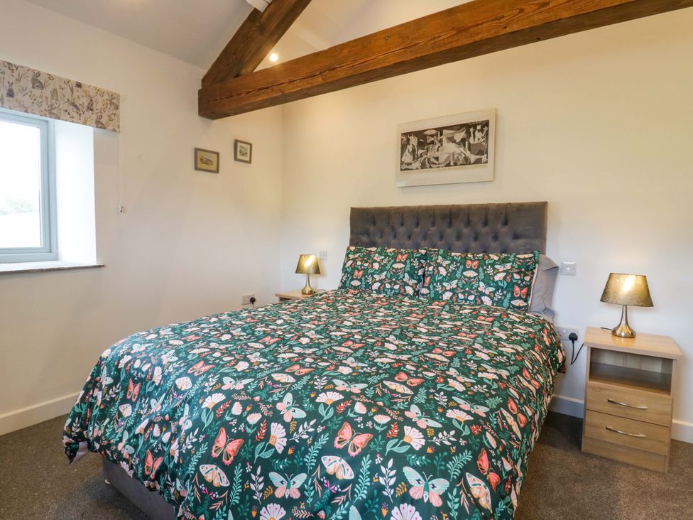 A bedroom with bed and nightstand at High Birks Barn Cautley near Sedbergh