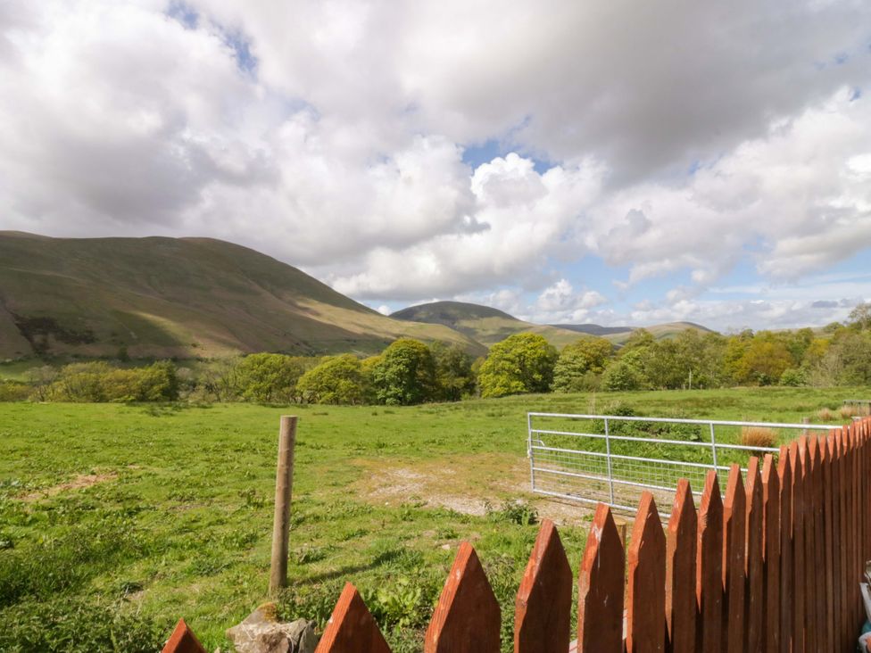 A landscape view with mountains and trees at High Birks Barn in Cautley near Sedbergh