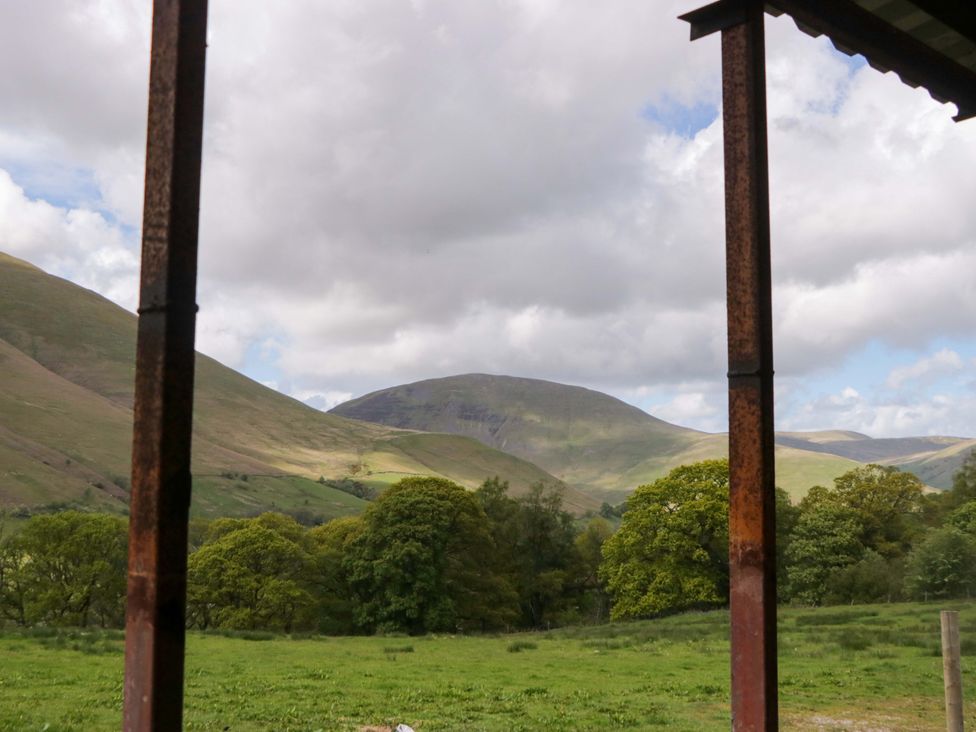 A view of mountains and trees at High Birks Barn Cautley near Sedbergh